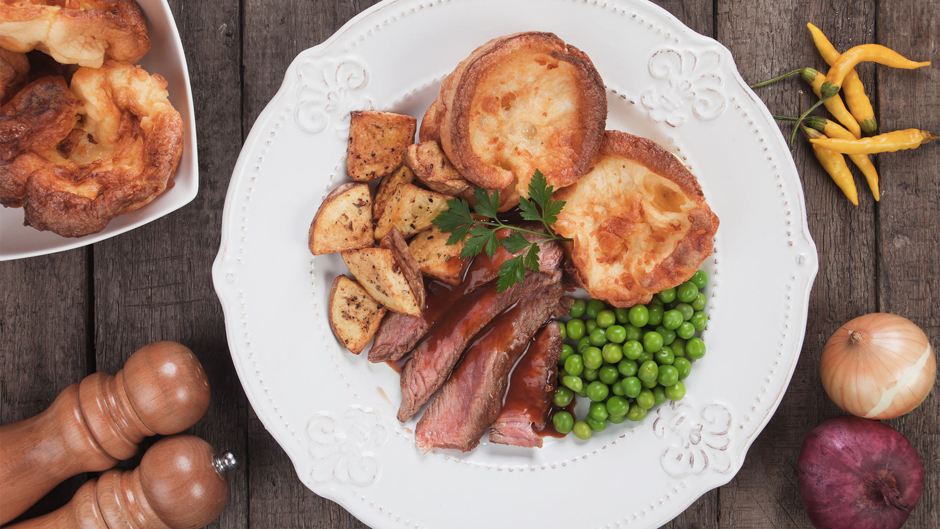 Roasted beef with Yorkshire pudding and vegetables on a plate at the best Sunday roast places in Singapore