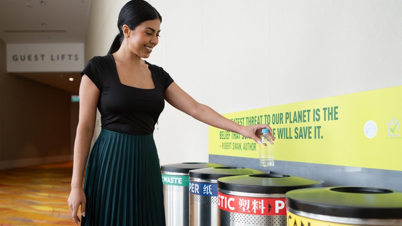 Woman using recycling bin