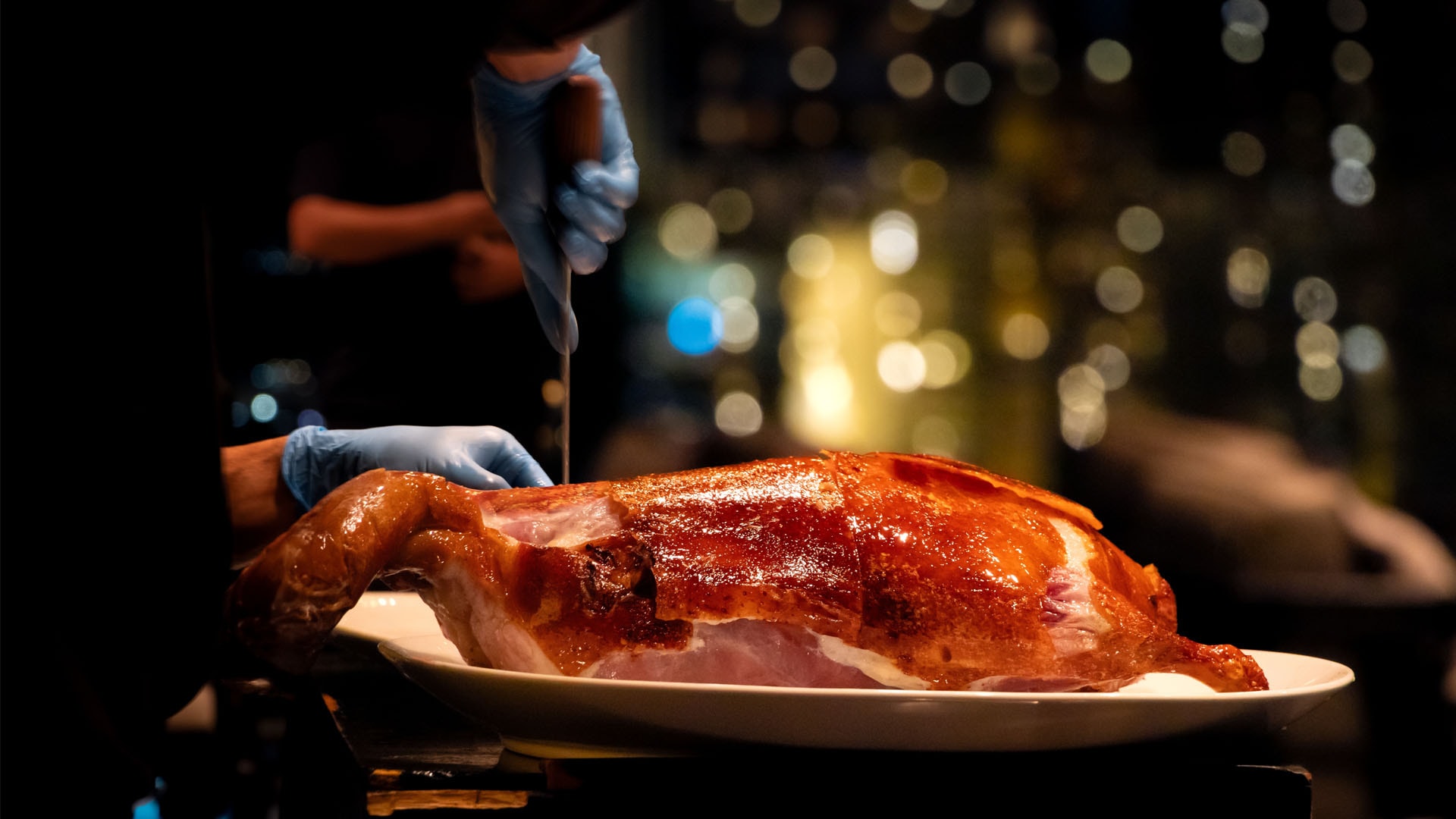 Peking Duck being sliced by chef