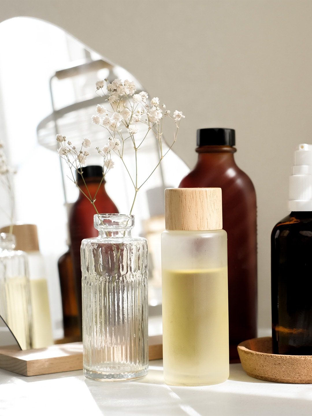 Bottles of skincare items on a vanity table from popular beauty and skincare brands