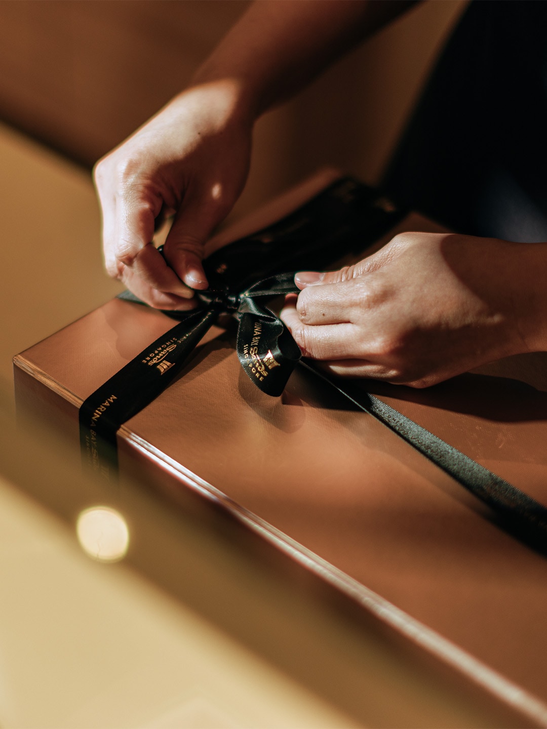 Person wrapping a housewarming gift in Singapore