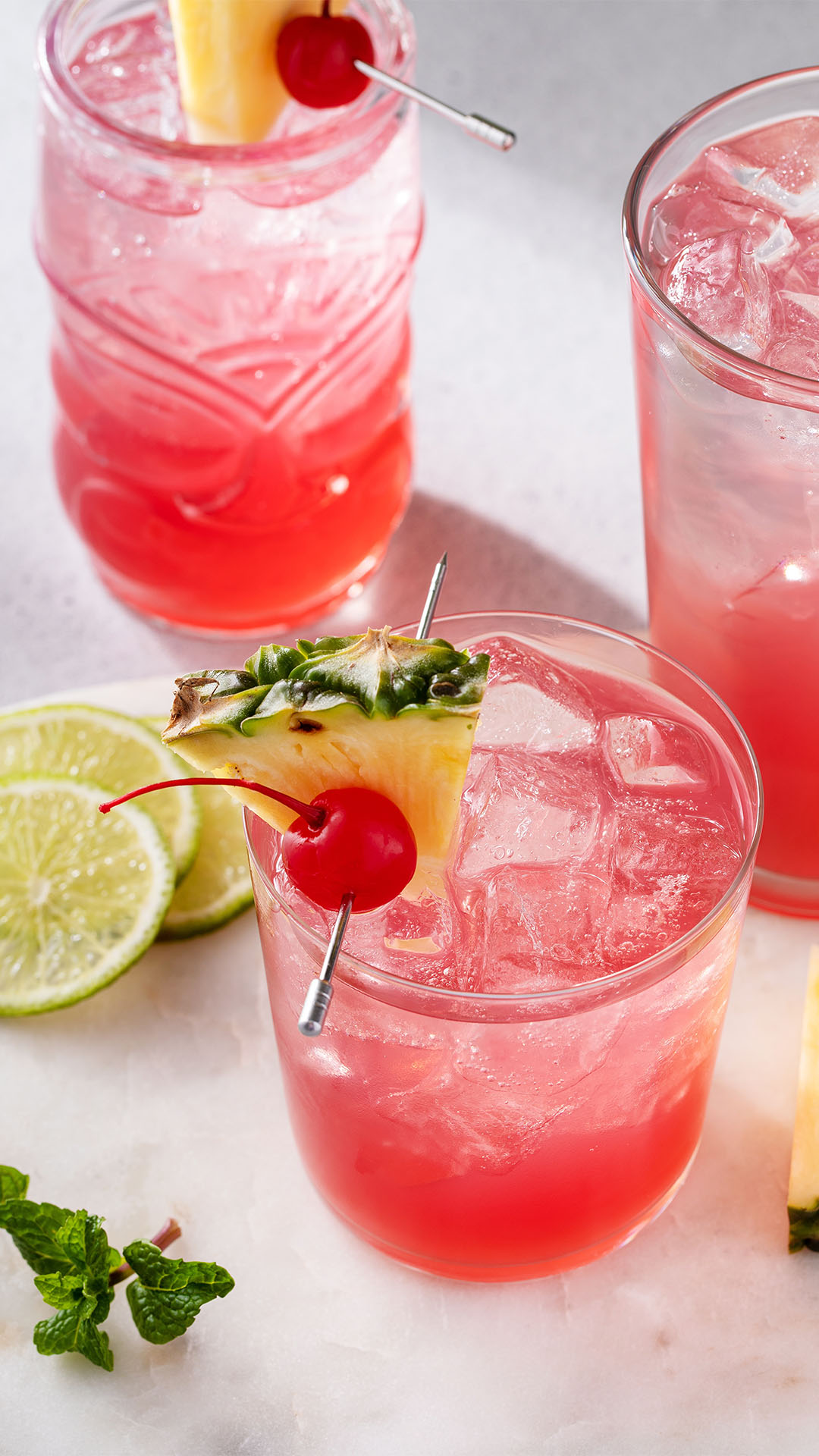 A glass of Singapore Sling, a cocktail in red with pineapple