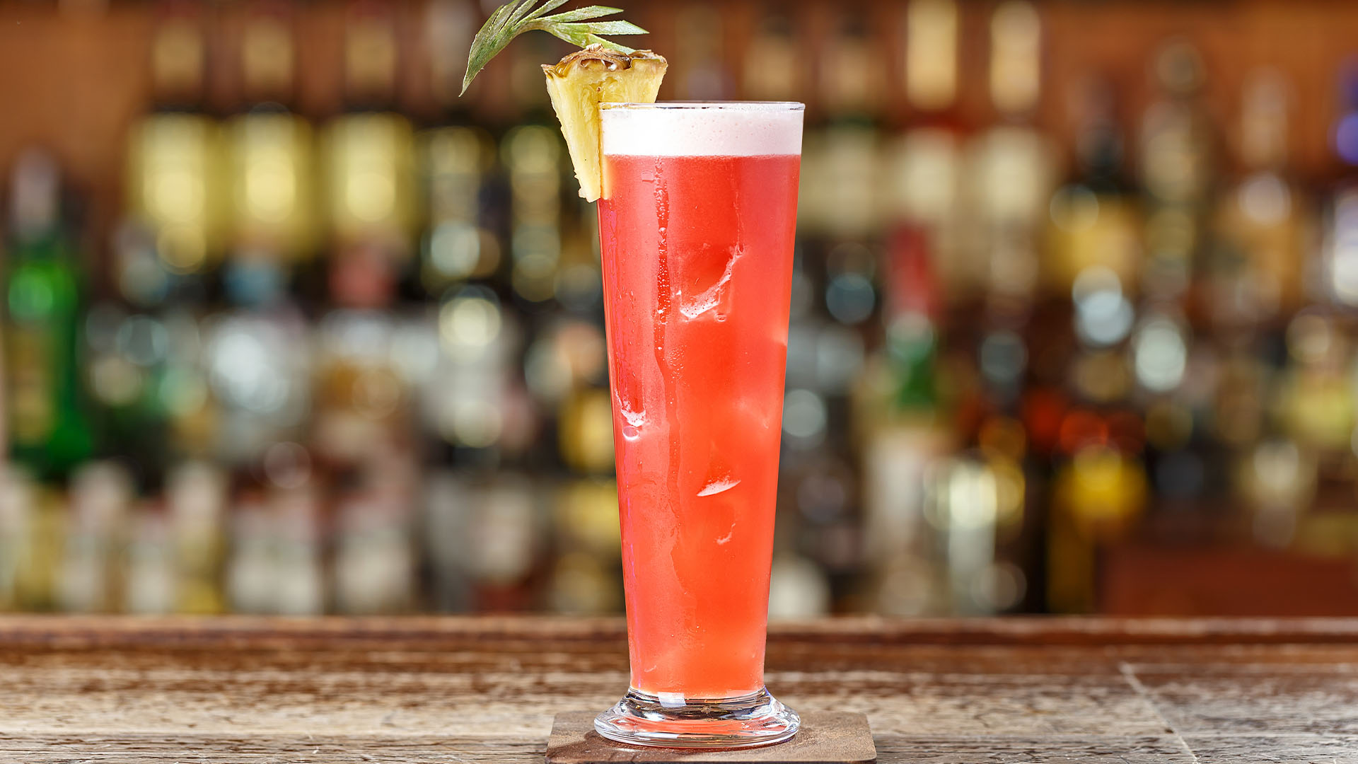 Singapore Sling in a tall glass, topped with pineapple