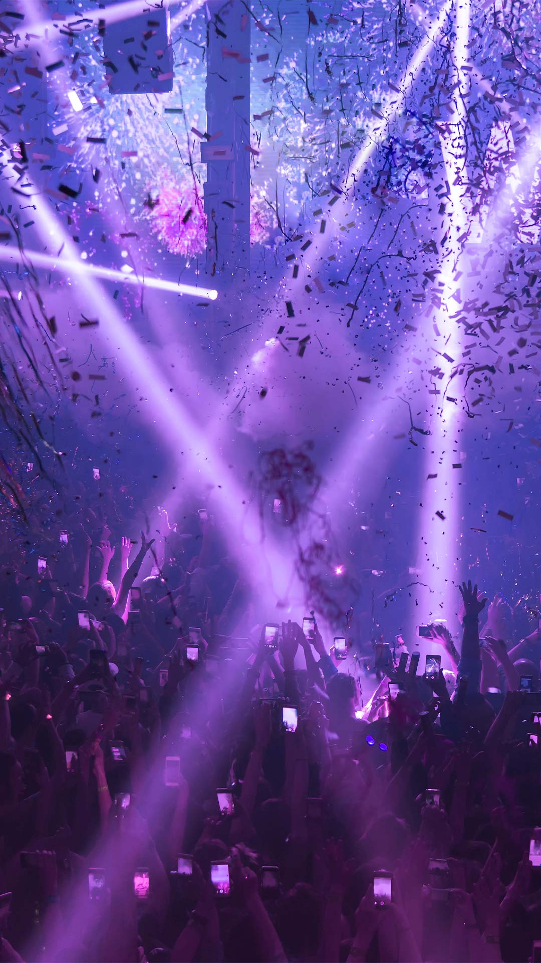 Silhouette and hands of a crowd enjoying a theme party in Singapore at a nightclub