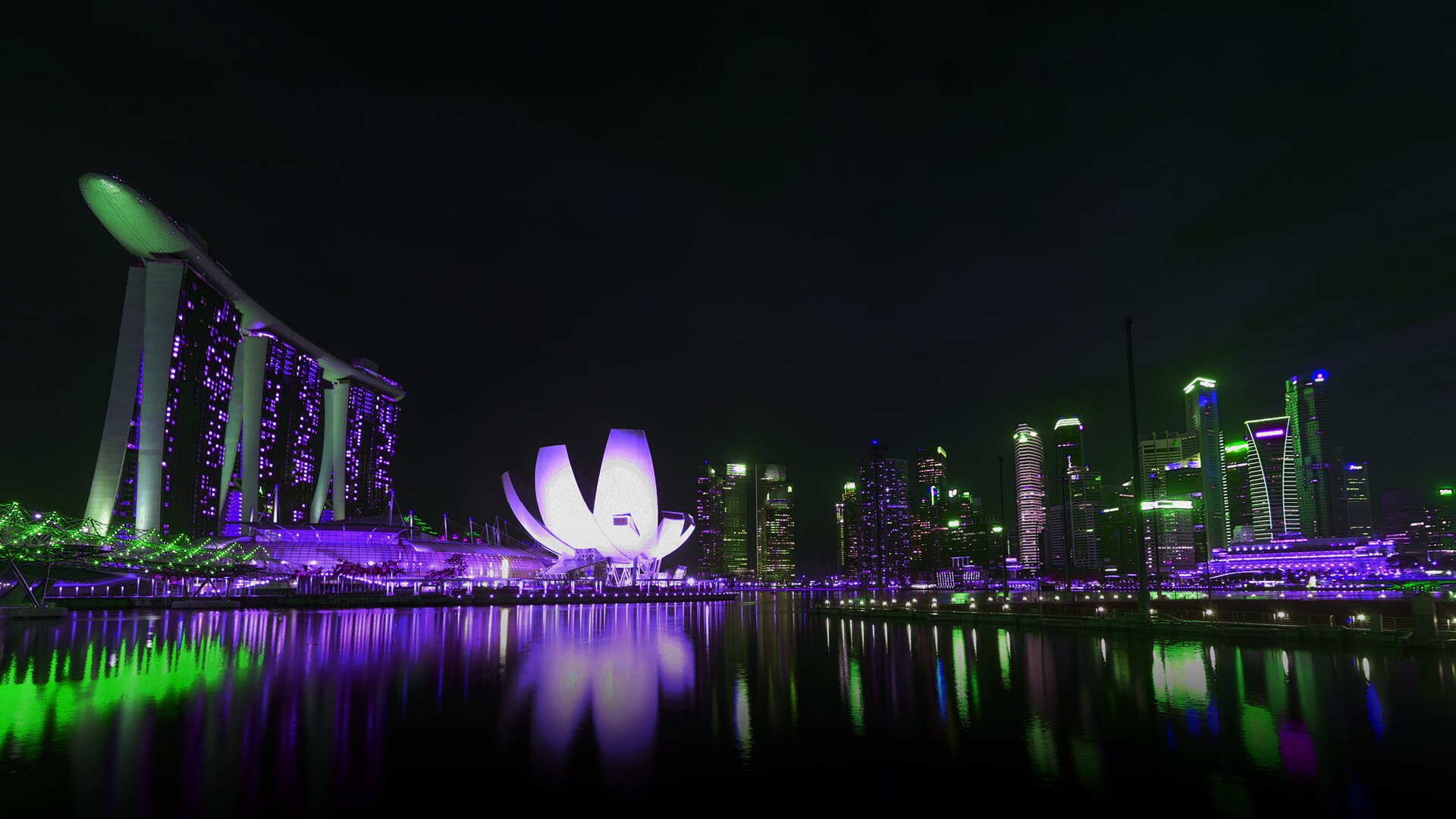 Facade of Marina Bay Sands illuminated in green and purple hues for 2024 Halloween in Singapore