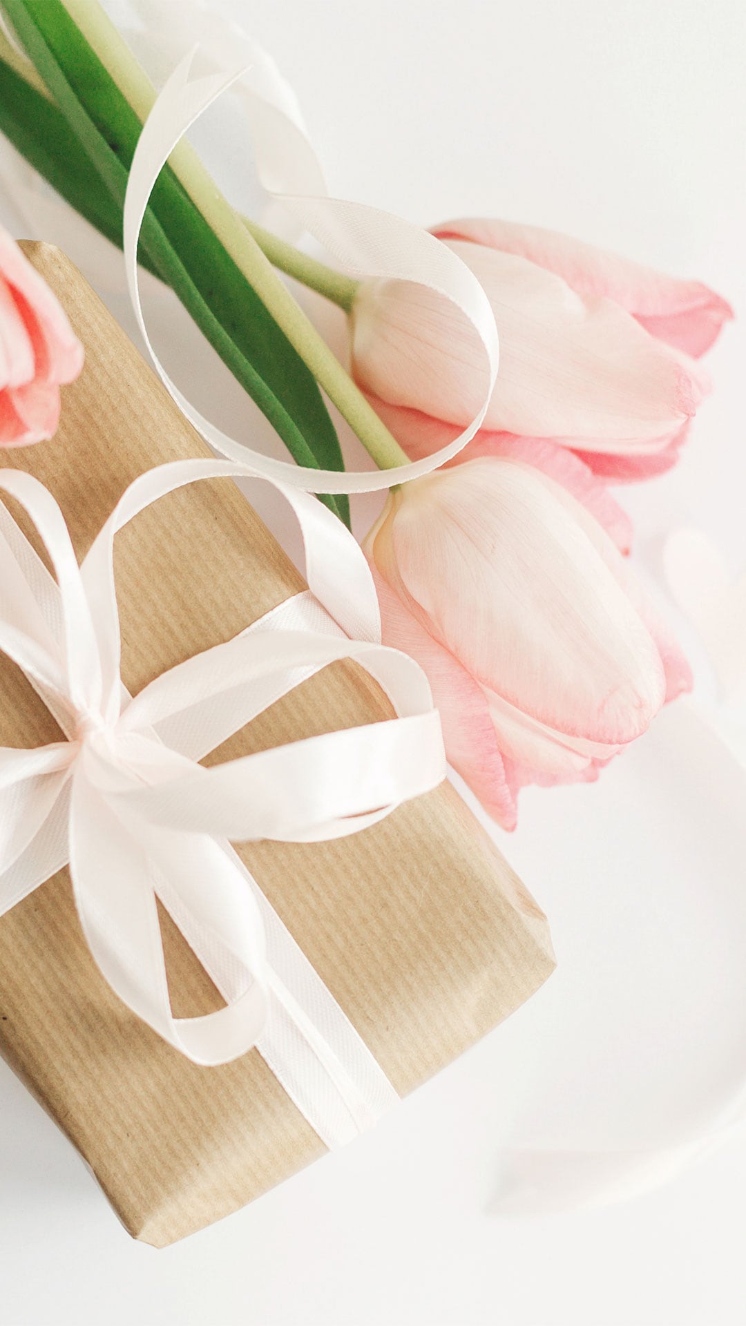 Brown gift box and pink tulips as Mother's Day gifts