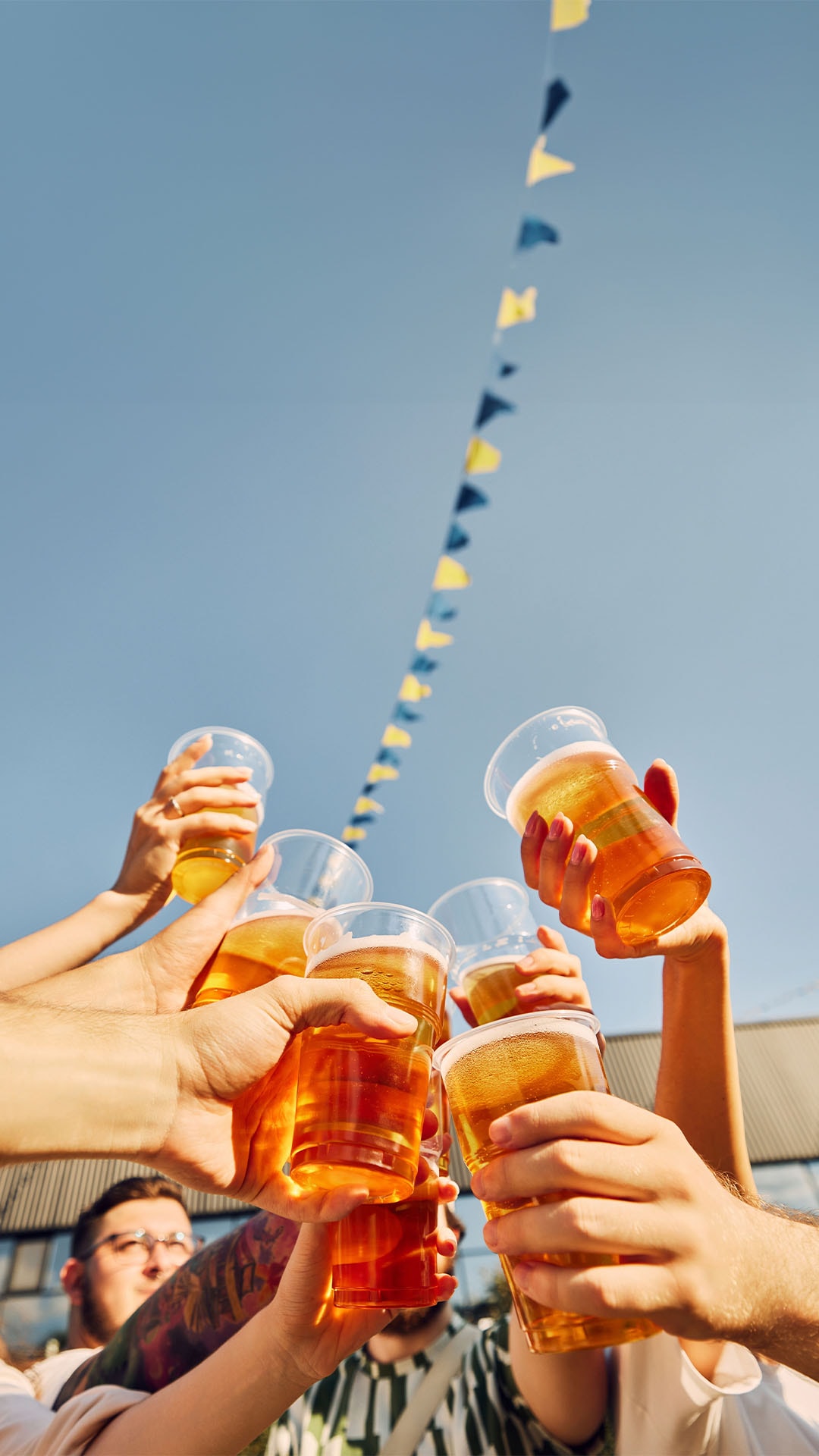 People celebrating Oktoberfest 2024 with a cup of German beer in hand