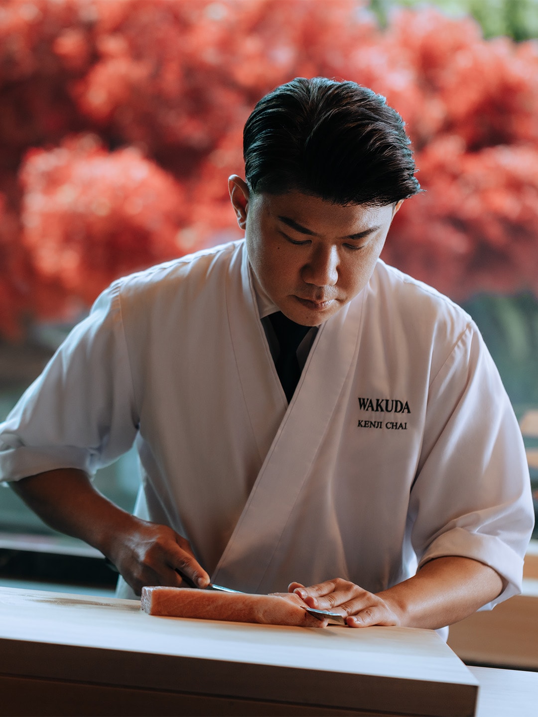 Chef from a Japanese restaurant in Singapore, preparing the perfect sashimi