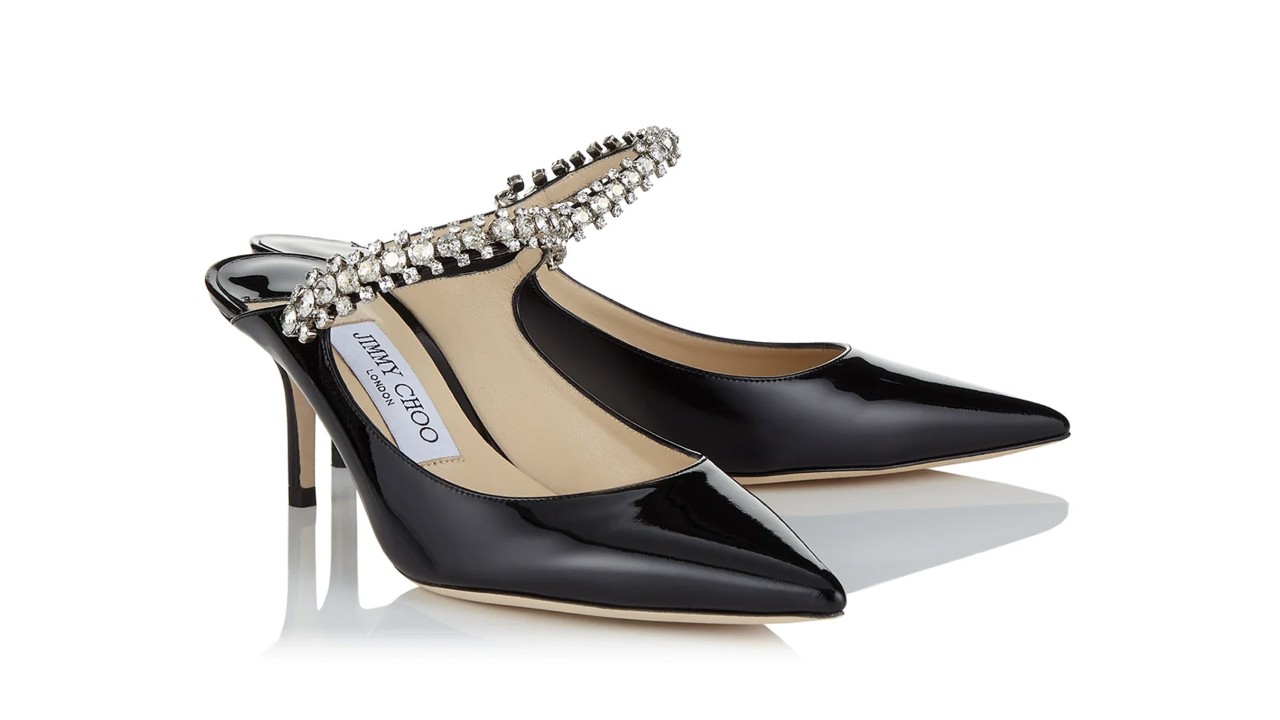 A pair of black shiny leather with a crystal strap across the top of the foot from top shoe brand, Jimmy Choo