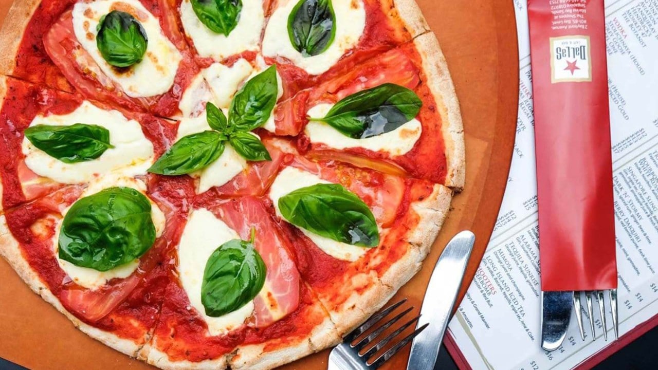 Dallas Cafe and Bar serving the best pizza in Singapore, topped with mozzarella cheese and fresh basil