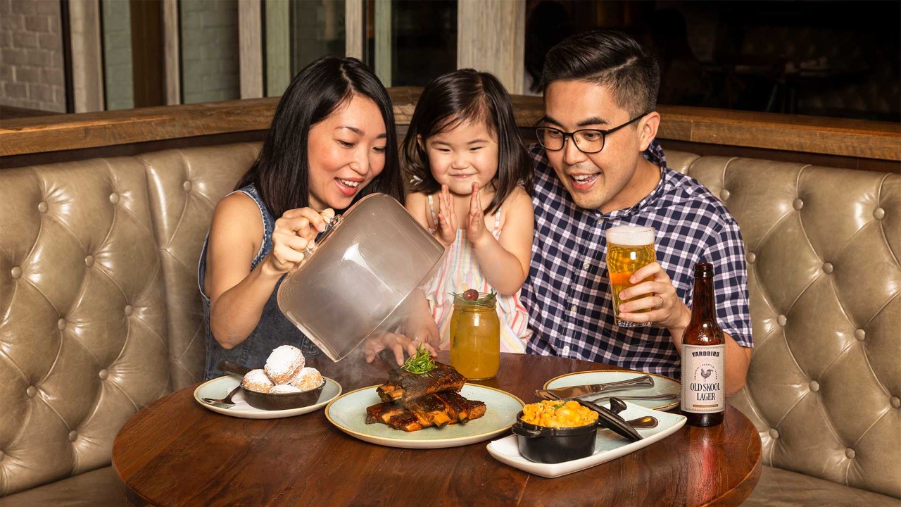 Family of three celebrating Father's Day 2024 with a dinner at Yardbird